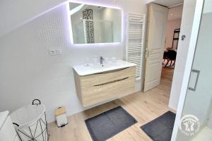 a white bathroom with a sink and a mirror at Ty jaudy in Trédarzec +37 photos