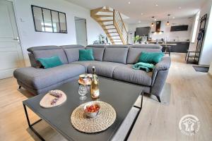 a living room with a couch and a table at Ty jaudy in Trédarzec