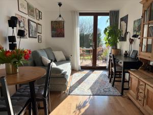 a living room with a couch and a table at Gallery - Terrasse mit Seeblick und Garten in Altmünster +37 photos