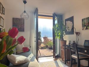 a living room with a door open to a patio at Gallery - Terrasse mit Seeblick und Garten in Altmünster