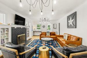 a living room with leather furniture and a fireplace at Union Retreat in Douglas