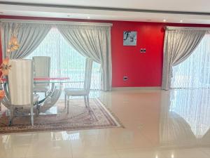 a dining room with red walls and a table and chairs at Mabee's Place in Durban +38 photos