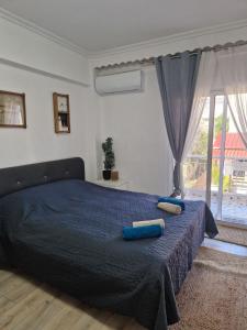 a bedroom with a bed with two pillows on it at Iraklia Pearl in Nea Irakleia