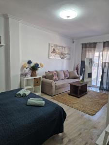 a living room with a bed and a couch at Iraklia Pearl in Nea Irakleia +4 photos