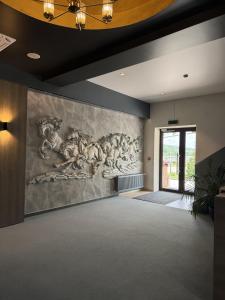 a large painting on the wall in a room with a hallway at Hotel Kazak Club in Chişinău