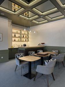 a restaurant with tables and chairs in a room at Hotel Kazak Club in Chişinău