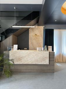 a lobby with a large reception desk with aazon sign on it at Hotel Kazak Club in Chişinău