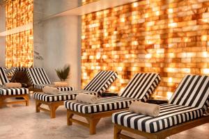 a row of chairs in a room with a wall at Radisson Collection Astorija Hotel, Vilnius in Vilnius +101 photos