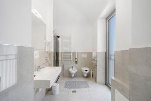 a white bathroom with a sink and a toilet at Affitta Camere Novara in Novara +49 photos