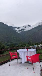 a table and chairs with a view of a mountain at Hotel NAR NARAYANA in Chutwāpīpal +7 photos