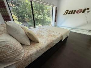 a bedroom with a bed and a large window at Loft Elegante Norte de Madrid in San Sebastián de los Reyes
