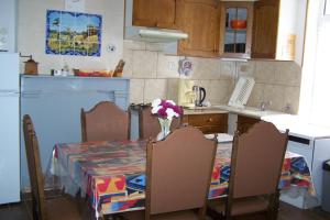 a kitchen with a table with a vase of flowers on it at gite les beaudries in Rilly-sur-Loire