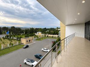 a balcony with cars parked in a parking lot at Arena Hotel Tartar in Terter