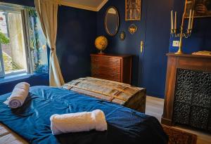 a blue bedroom with a bed and a dresser at Le refuge des explorateurs - chasse au trésor in La Flèche +24 photos