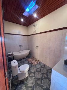 a bathroom with a toilet and a bath tub at Intan Villa & Suite Ubud in Ubud +30 photos