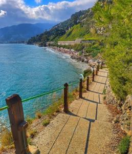 a path leading down to a beach next to the water at La Casa di Vale in Ventimiglia