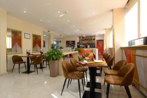 a dining room with a table and chairs at Hotel The Brand in Rome