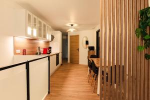 a kitchen and dining room with a table in a house at La Cave Voutée - Home Cinema in Valence