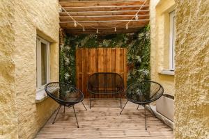 two chairs and a table on a patio at La Cave Voutée - Home Cinema in Valence