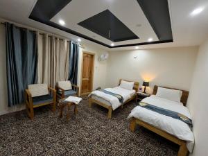 a hotel room with two beds and a window at cloudrestskardu in Skardu
