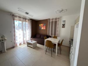 a living room with a couch and a table at Apartman Irena in Pula