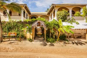 a house on the beach with palm trees at Villa Medina Oasis in Jericoacoara