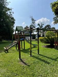 a playground with a slide in a park at Hotel Campestre Santa Lucia in Montenegro