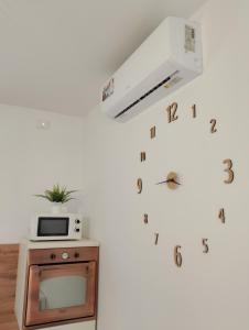 a room with a tv and a clock on the wall at Casa Paglietta None in None +1 photo