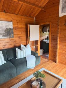a living room with a couch and a table at Swan cove - Lakeside Caravan Park in Denver