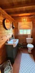 a bathroom with a sink and a toilet in a cabin at Swan cove - Lakeside Caravan Park in Denver