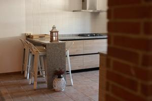 a kitchen with a table and chairs and a counter at Camino Real in Jerte +5 photos