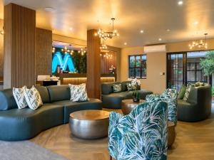 a living room with couches and a table at Menlyn Mix in Pretoria