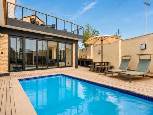 a house with a swimming pool and a patio at Menlyn Mix in Pretoria +51 photos