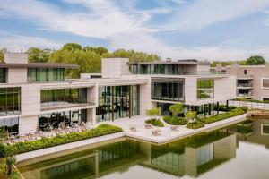 an exterior view of a building with a body of water at Radisson Collection The National Hotel, Brussels in Zaventem