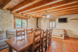 a dining room with a table and a couch at Sanz in Castro de Fuentidueña