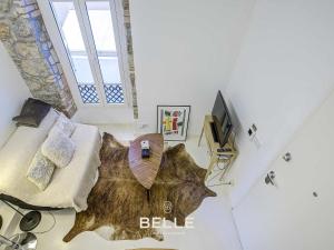 a living room with a large fish rug on the floor at Rocher - 3min Port Hercule - Casino in Monte Carlo