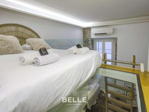 a bedroom with a large bed with towels on it at Rocher - 3min Port Hercule - Casino in Monte Carlo +2 photos