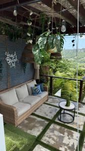a couch sitting on a patio with a table at Private Oasis with Jacuzzi & Pool for Two in Ciales