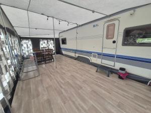 a room with a rv and a table and chairs at Camping Obłazek in Piwniczna-Zdrój