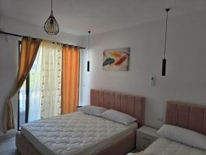 a bedroom with a bed and a window at Hotel Bar Pizzeria Verona in Ksamil