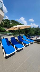 a group of blue chairs and an umbrella on a roof at Val Lux Apartmani in Sutomore