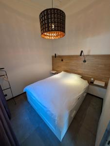 a bedroom with a white bed and two lights at Vecbulduri Apartment Jurmala in Jūrmala