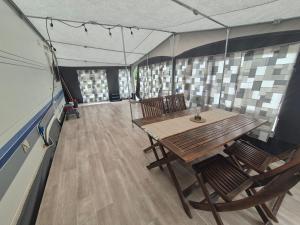 a dining room with a table and chairs in a tent at Camping Obłazek in Piwniczna-Zdrój