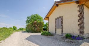 a building with a door on the side of a road at La met au loup in Charmont-sous-Barbuise