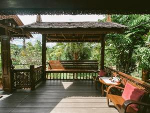 a gazebo with a bench on a deck at Rommai Villa Chiang Rai in Ban Pa Sang (1)