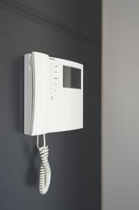 a white phone hanging on a wall at Apartment Caprice in Zadar