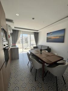 a dining room with a table and chairs in a room at Seaview Marsaxlokk Apartment Eye of Osiris in Marsaxlokk