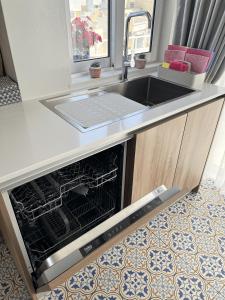 a kitchen with a sink and an oven at Seaview Marsaxlokk Apartment Eye of Osiris in Marsaxlokk +27 photos