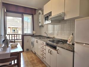 a kitchen with a sink and a stove top oven at Apartamento Viento y Marea 20811 in Argoños