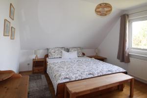 a bedroom with a bed and a window at Ferienhaus Uli in Wustrow